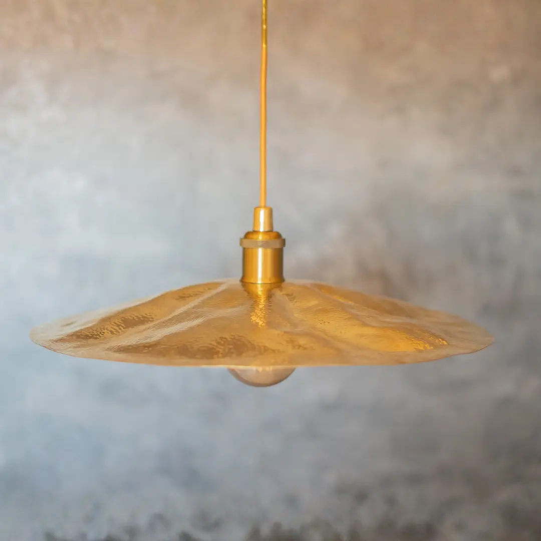 Flat Brass Disc Pendant in Interior Setting